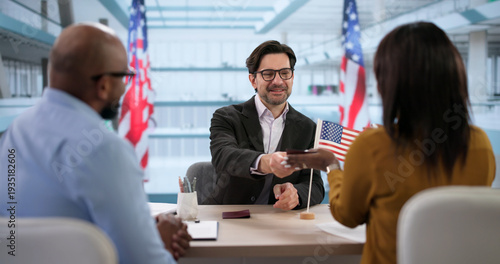 Valokuva Happy Couple Smiles While An Immigration Lawyer Helps With Green Card Approval