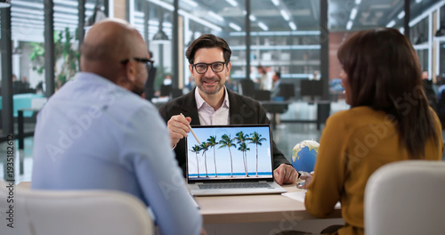 Travel Agent Helping A Smiling Family Plan Their Cruise Vacation