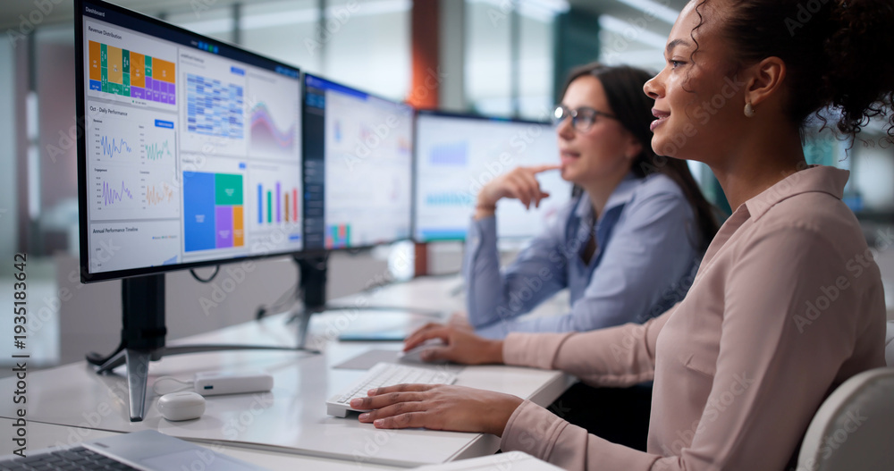 Naklejka premium Female Analysts Evaluate Financial Data, Monitor Screens