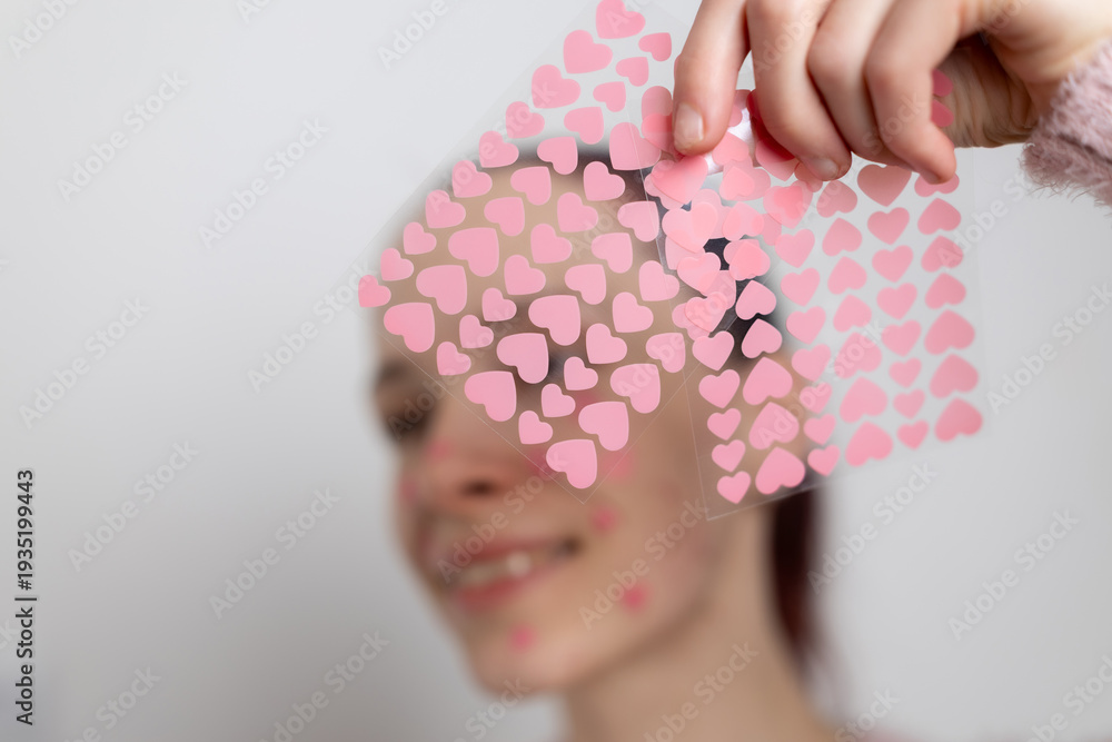 Ταπετσαρία Hand holding colorful heart shaped acne patches for skincare treatment