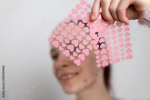 Konstfotografi Hand holding colorful heart shaped acne patches for skincare treatment