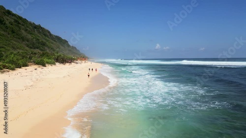 Aerial view of Nyang Nyang Beach in Bali with tropical sand coastline and blue ocean waves. High quality 4k footage