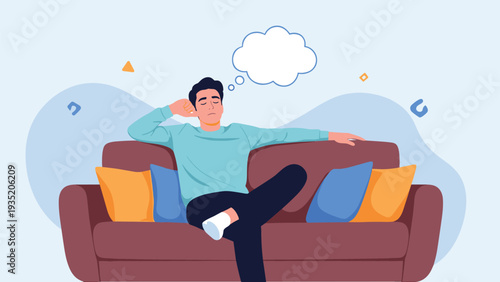 Young man sits comfortably on a brown sofa and thinks deeply with a blank white thought bubble above his head.