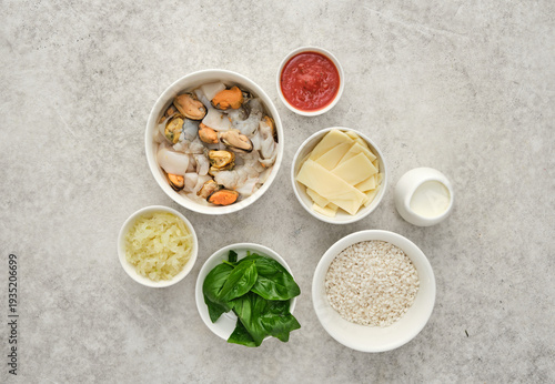 Preparation of seafood risotto with various ingredients in a kitchen setting at mealtime