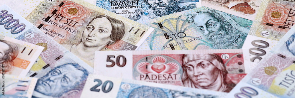 Obraz premium Czech koruna money bills pile on table. Czech Republic banknotes of CZK currency close up.