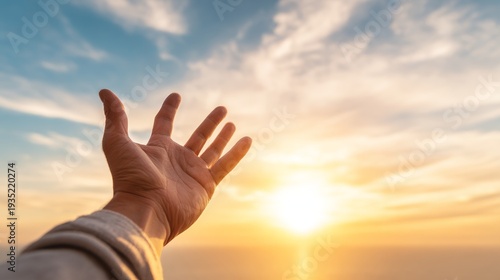 Reaching for hope a person's hand against a vibrant sunset at the seaside emphasizing optimism and connection
