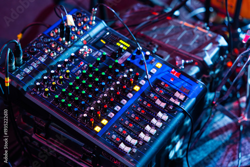 Compact Analog Audio Mixer with Connected Cables and Glowing Indicators on Stage