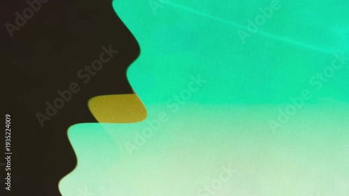 Abstract silhouette profile motion in green gradient video.