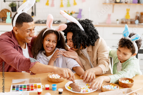 Photos Family wearing bunny ears enjoying Easter celebration, decorating eggs and havin