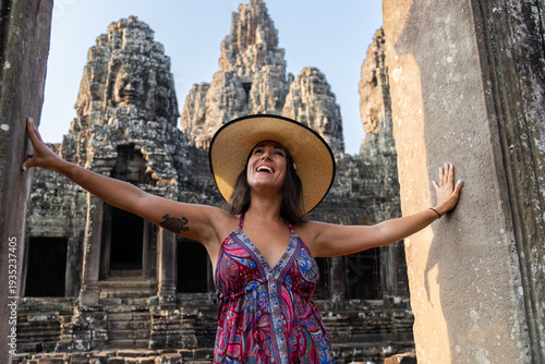 Woman joyfully experiencing ancient temple ruins in cambodia