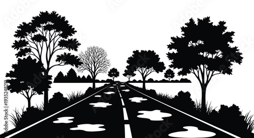 A solitary road stretches into the distance framed by silhouetted trees