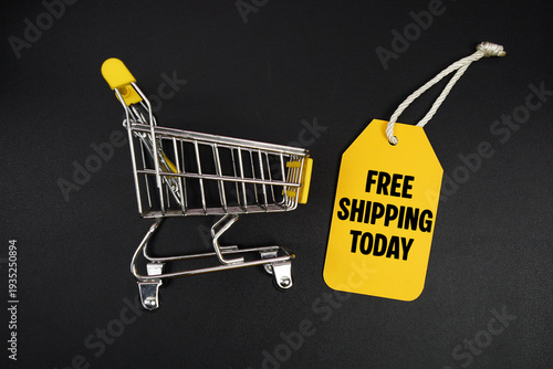 Fotografie Mini Trolley Shopping Cart and price tag with message Free Shipping Today on b