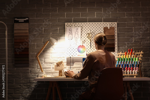 Female tailor sewing clothe...