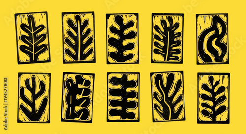 A collection of black leaf designs in rectangular frames on a yellow surface viewed from directly above showcasing various leaf patterns