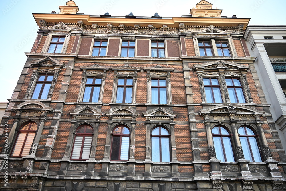 Fototapeta premium Low angle view of historic red brick townhouse facade in Torun Poland 