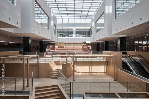 Modern atrium interior with skylight and open balconies.