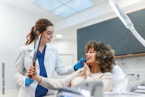 Wallpaper Mural Patient looking at results in mirror. Facial treatment, Healthcare And Medicine concept. Attractive smiling woman in clinic chair with female doctor in white coat. Professional aesthetic medical care. Torontodigital.ca