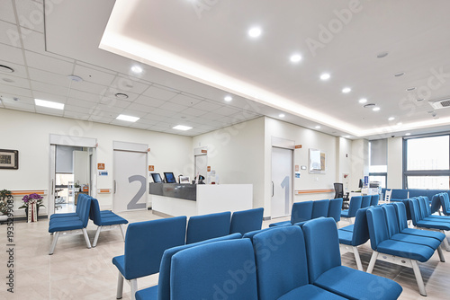 Clean modern hospital or clinic interior with patient beds and medical facility lighting.