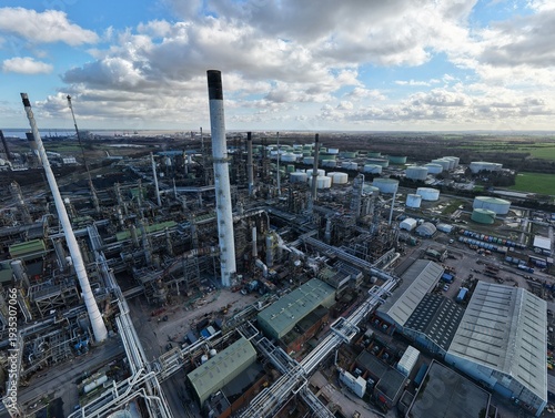 Wallpaper Mural Aerial view of the sprawling industrial complex of Humber Refinery, with its towering smokestacks piercing the sky against a backdrop of patterned clouds, Immingham, United Kingdom. Torontodigital.ca