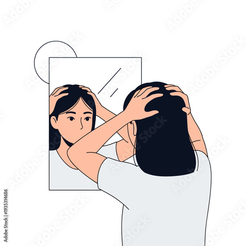 Young woman looking at herself in mirror while holding her head  