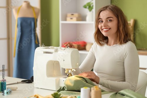 Young female tailor sewing ...