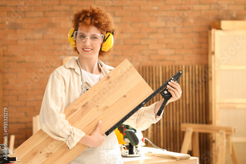 Young female carpenter with...