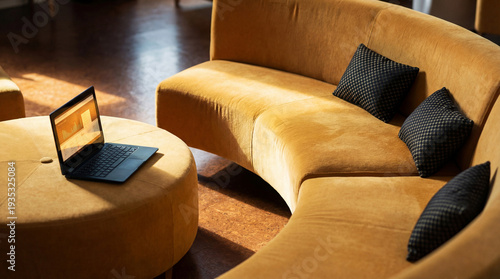 Fotografía Contemporary office lounge area with comfortable yellow sofa, ottoman, and laptop, creating a relaxed yet productive atmosphere