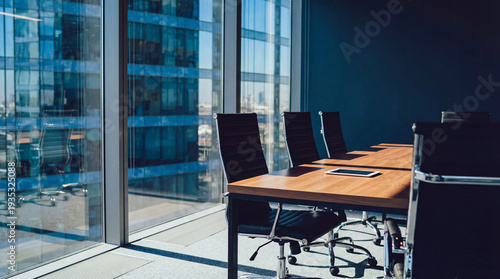 Bild auf Leinwand Modern office meeting room with large windows overlooking a cityscape, featuring a conference table and chairs with a tablet device, perfect for corporate presentations and business discussions