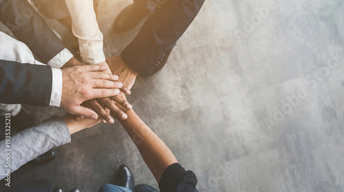 Fotografia An intimate close-up shot of several business professionals' hands stacked in a powerful display of team unity and shared purpose