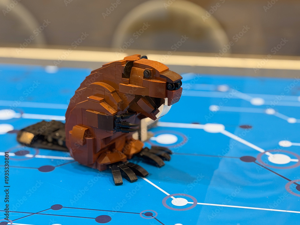 Fototapeta premium Brown beaver brick model on blue surface