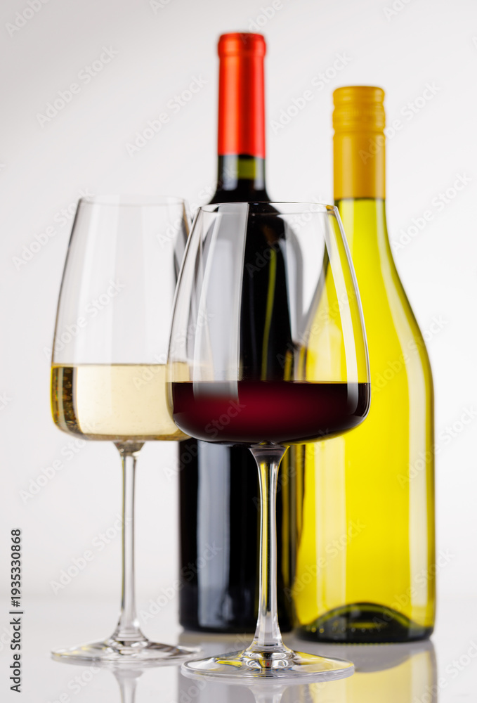Fototapeta premium Different wine bottles and glasses on white background