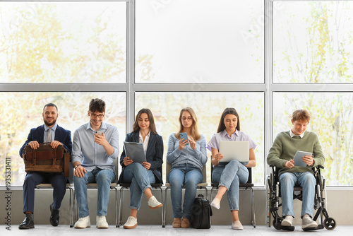 Cuadro en lienzo Young job applicants with man in wheelchair waiting for interview at office