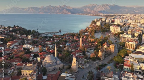 Wallpaper Mural Sunset aerial view of Antalya old town with historic mosques and clock tower, beautiful cityscape of Kaleici district against Taurus mountains. Beautiful Turkish city of Antalya at sunset Torontodigital.ca