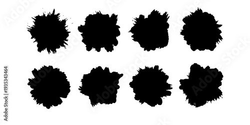 Eight black ink blots on white background