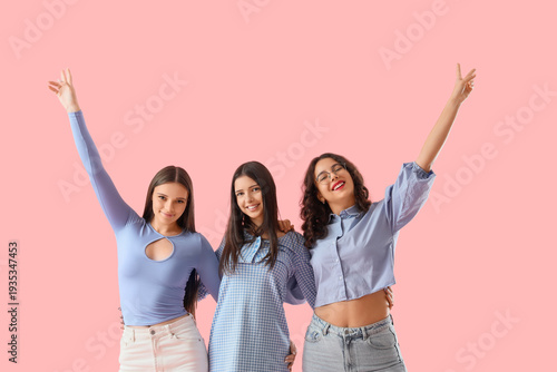 Happy teenage girls on pink...