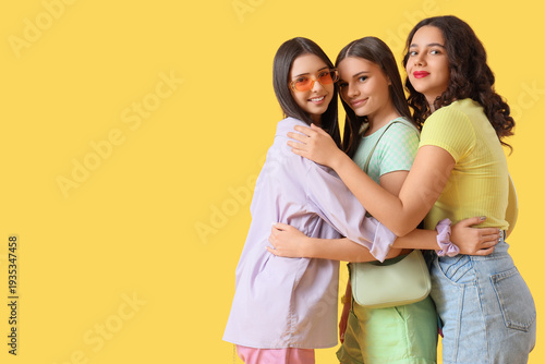 Happy teenage girls hugging...