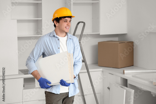 Male worker with shelves as...