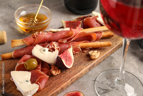 Board with tasty jamon slic...