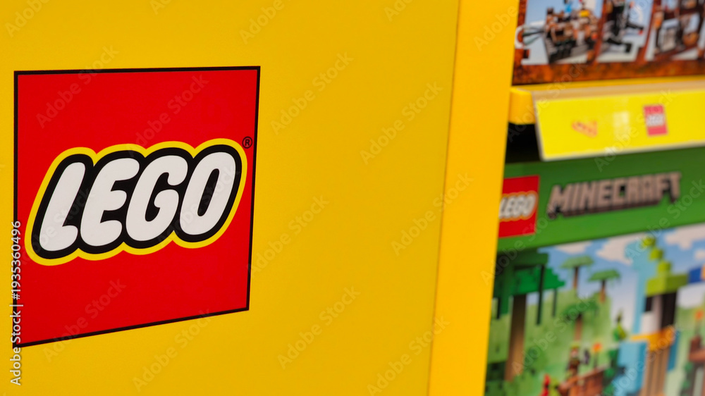 Fototapeta premium Close up of iconic red and white Lego logo sign on a yellow shelf in a retail toy store on January 3, 2025 in Bangkok, Thailand.
