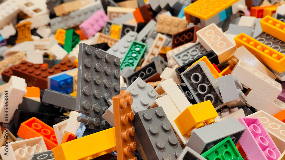 Naklejka premium Close up view of various colorful LEGO plastic building bricks and toy blocks in many different shapes and sizes on September 15, 2025 in Bangkok, Thailand.