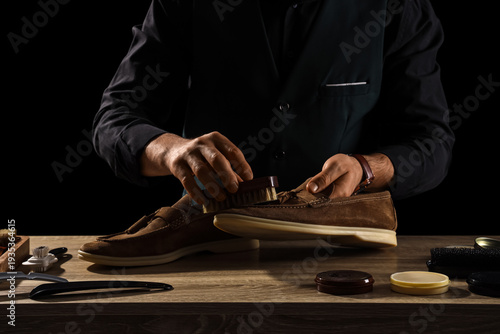 Male shoemaker polishing su...