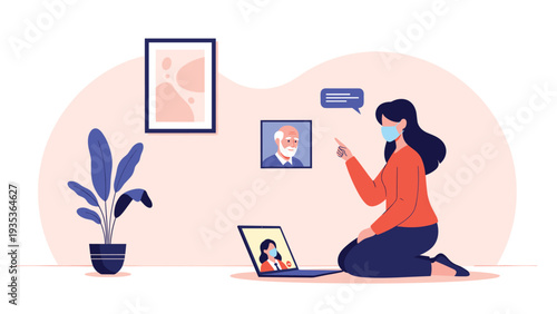 Woman wearing a protective face mask having a video call with her family on a laptop while kneeling on the floor in a modern home interior setting.