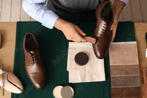 Male shoemaker polishing sh...
