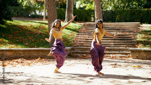 Fotografie Two indian women performing classical indian dance, displaying culture and elega