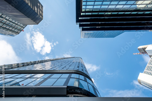 Modern glass skyscrapers architecture rising upward in the financial district of Frankfurt Germany under clear sky with strong city lines