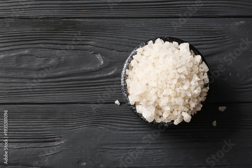 Bowl of sea salt on dark wo...