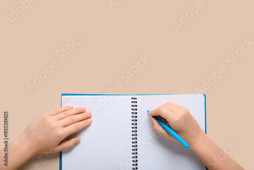 Female hands writing in not...