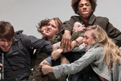 Bild auf Leinwand Group of 6 young adults fighting with each other for space