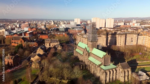 Drone view of Glasgow Cathedral and city skyline with restoration work during a sunny day