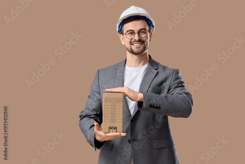 Male architect with cardboa...